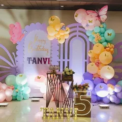 A full view of the pastel butterfly stage, showing the soft color palette of the balloons and props.
