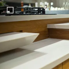 A close-up of a multi-level countertop, an innovative design feature that adds dimension and separates work zones within the kitchen.