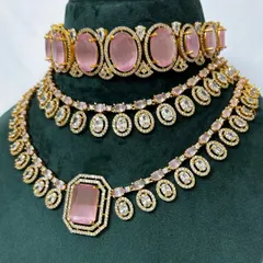 A close-up of the pink stone necklace set. The combination of the choker and necklace creates a full and festive look, available for rent.