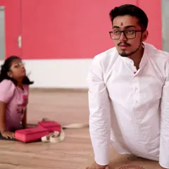 In this photo, you can see me demonstrating Bhujangasana (Cobra Pose) while a young student mirrors the posture in the background. This is how I teach, by doing it with them, ensuring they understand the form and feel of the pose correctly.