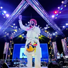 Under the bright lights of the Navratri stage, commanding the attention of the massive audience. My custom-painted kurta adds to the festive performance.