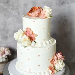 Two tiers of love, frosted in delicious Belgian chocolate. This cake, decorated with fresh flowers and tiny hearts, is a beautiful centerpiece for any wedding or engagement party.