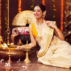 A jewellery campaign with a traditional South Indian theme. The warm lighting from the diyas creates a beautiful, festive glow, highlighting the intricate gold jewellery and the classic Kasavu saree.