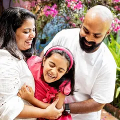 A big family hug full of laughter and joy. This photo perfectly captures the fun and energetic spirit of this family during their outdoor photoshoot. Real emotions always make the best pictures.