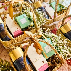 For large corporate events or wedding favors, I can produce beautiful, consistent hampers at scale. This image shows a batch of hand-woven baskets, each filled with premium coffee, cookies, and delicate baby's breath, ready for delivery.