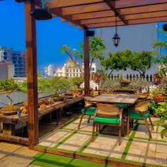 This rooftop terrace offers a stunning view of the city. We designed it with a wooden pergola, rustic bench seating, and an abundance of plants to create a green, vibrant oasis high above the urban landscape.