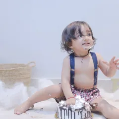 This little guy is getting right into his first birthday cake. We love capturing the hilarious and heartwarming chaos of a cake smash.