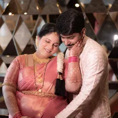 During a traditional Godh Bharai ceremony, there are so many moments of quiet love. Here, the father-to-be gently holds his wife and their baby bump, a beautiful portrait of support and shared joy.