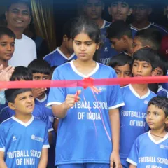 A close-up of the ribbon-cutting, with one of our young female players doing the honors, symbolizing our commitment to future generations.