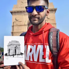 Standing in front of India Gate in Delhi with a pen sketch I drew on location. I enjoy urban sketching and capturing the beauty of architectural landmarks.