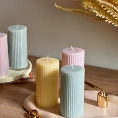 A collection of our ribbed pillar candles in soft pastel colors. Available in a wide variety of shades, these dripless candles are perfect for adding a touch of color and style to your home decor.