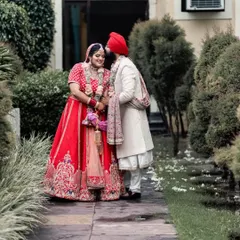 A tender moment where the groom whispers to his bride. This quiet, intimate interaction, captured outdoors, tells a story of their close bond and shared secrets on their wedding day.