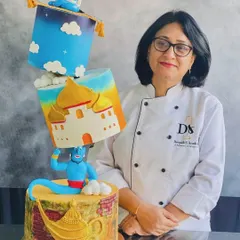 One of my proudest creations, a 15kg topsy-turvy Arabian Nights cake with handmade Genie and Jasmine toppers.