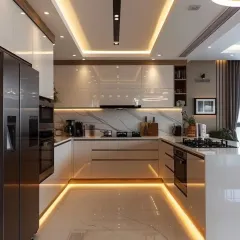 We designed this U-shaped kitchen for maximum efficiency and style, featuring high-gloss white cabinetry and warm wood accents. The integrated under-cabinet and ceiling cove lighting creates a bright, welcoming atmosphere at any time of day.
