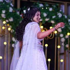 A candid moment of the bride dancing at her Sangeet. The makeup is designed to be long-lasting and photo-ready, even during high-energy performances.