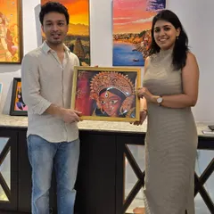 A proud new owner and the artist pose with the sold Durga painting, celebrating the connection made between creator and collector at our gallery.