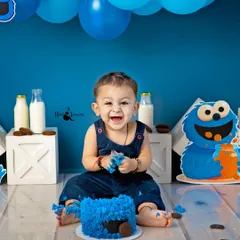 The pure, uncontainable joy of a first birthday cake smash! This little Cookie Monster's laughter is absolutely infectious, making for a truly memorable and fun-filled session.