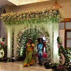 A stunning floral entrance tunnel for a wedding. Guests walk through this beautiful passage of flowers, making for a grand and memorable arrival experience.