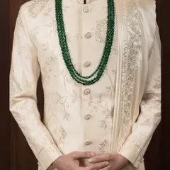 The details make the difference. This close-up shows the texture of the fabric and the precision of the tonal embroidery on our classic ivory sherwani, a hallmark of our bespoke tailoring.