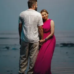 Reflections of love by the sea. Jaspal rests her head on Nishant's shoulder as they stand in the water, a quiet moment of connection captured beautifully.