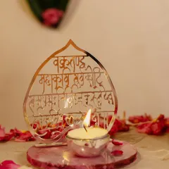 This piece combines light and prayer. I designed this silver-plated stand with the 'Vakratunda Mahakaya' mantra intricately cut out, creating a beautiful silhouette when the accompanying candle is lit. It rests on a rose quartz base, adding a touch of serenity.