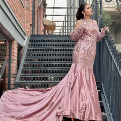For a glamorous reception or engagement, I styled this client in a stunning pink mermaid gown with a long train. The makeup is kept modern and chic with a sleek ponytail to complement the outfit.