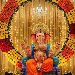 This is one of my signature Ganpati decorations. The grand circular arch made of fresh marigolds in orange, yellow, and red creates a vibrant and traditional backdrop, perfectly complemented by the warm glow of fairy lights and a grand chandelier.