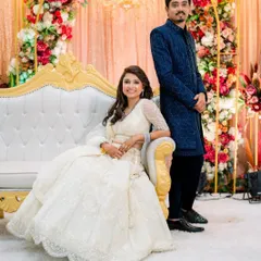 Posing together, you can see how the clean lines of his outfit complement the flowing grace of hers. This is how we ensure you look great both individually and as a pair.
