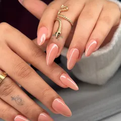The perfect nude. These long, almond-shaped nails feature a soft, peachy-nude polish that is elegant, versatile, and always in style.