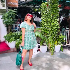 Another angle of the green leaf-print dress, showing how the outfit looks from a slightly different perspective.