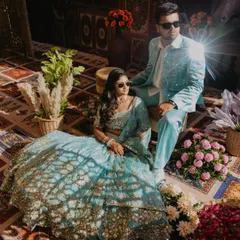 A stylish couple portrait from a Haldi carnival. The unique lighting on their coordinated outfits and the cool sunglasses give this shot a modern, editorial feel, showcasing a different take on Haldi photography.