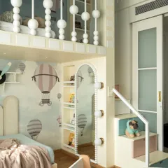 Another view of the playhouse-themed kids' room, showing the loft bed with its charming bead-inspired railings. The space is designed to be a fun and inspiring environment for growth and play.