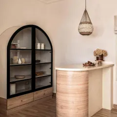 This image, featured in Architectural Digest, showcases the custom bar and arched cabinetry I designed for the Ivy Lane Villa. It highlights my work in preserving heritage while infusing modern functionality.