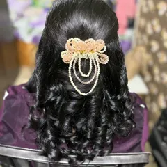 A simple yet elegant hairdo created based on the client's request. The soft curls are gathered at the back with a beautiful pearl and bead hair accessory.