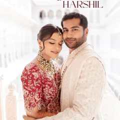 A tender moment shared between the bride and groom, framed by the majestic white architecture of a palace. This is the timeless elegance we strive to capture in our royal wedding photography.