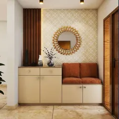 This entryway design features a cabinet with a comfortable two-seater bench. The unit is complemented by a decorative mirror and a wood-paneled accent wall.