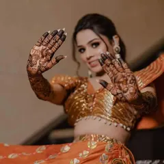 A stunning shot of a bride showing her palms, covered in our signature storytelling mehndi.