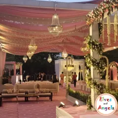 I transformed this large venue into a dreamy wonderland for a Sangeet night. By draping the ceiling with soft pink fabric and weaving in thousands of fairy lights, I created a magical canopy. Crystal chandeliers added a touch of grandeur, setting a romantic and celebratory mood for an evening of dance and music.