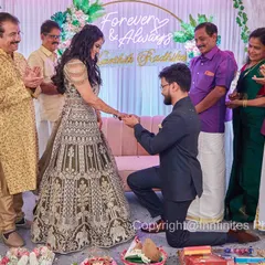 The pivotal moment of the proposal during an engagement ceremony, surrounded by the warm applause of family. I ensure I am positioned to capture this once-in-a-lifetime memory from the best angle.