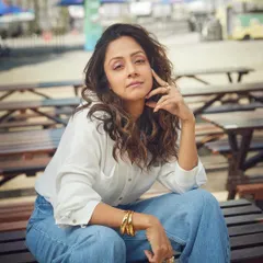 A more serious and editorial pose, showing how a simple denim look can be elevated with the right attitude and accessories.