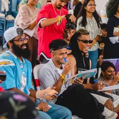 The judges and audience enjoying the battles at Spectra 2023. The vibe is always supportive, with everyone cheering each other on.