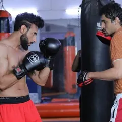 It was an honor to train Rahul Makin, one of the best voices on the radio, as he stepped from the studio into the ring. Here I am holding the pads for him, working on his boxing technique and power.