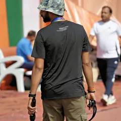On the track during the Khelo Masters Games, coordinating the event with a microphone in hand. My job is to be on the ground, managing the flow of the competition.