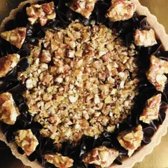 This overhead shot captures the beautiful contrast between the dark, silky chocolate and the golden, crunchy almond topping.