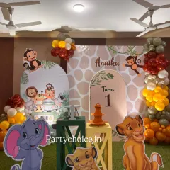 A closer look at the details of our jungle theme decor, showing the custom arched backdrops and character cutouts of Simba, Dumbo, and monkeys that make the setup so engaging for children.