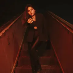 A low-light portrait on a derelict escalator, lit with a dramatic red gel. This technique creates a gritty, cinematic, and slightly futuristic look, perfect for an edgy fashion shoot.
