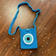 This trendy Evil Eye crossbody bag is perfect for a casual day out. It's just the right size for your essentials and adds a cool, protective symbol to your look.