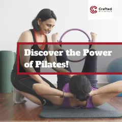 Discover the power of Pilates! This image shows me assisting a student with a Pilates ring, a prop you'll learn to use to enhance workouts. This is the kind of hands-on guidance I provide.