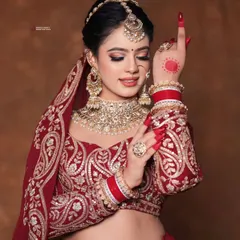 The quintessential bridal look. Here, the bride's classic red nails and alta-stained hands are the perfect finishing touch to her radiant makeup and magnificent jewelry.