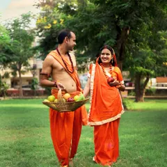 This couple is walking hand-in-hand, styled as Ram and Sita, in a lovely green park. We use simple props like a fruit basket to make the scene feel authentic and timeless.